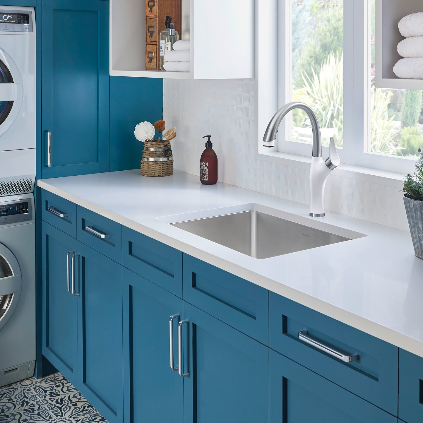 BLANCO Quatrus R15 25" Single Bowl Dual Mount Stainless Steel Laundry Sink in a stylish blue laundry room.