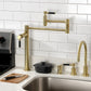 Kingston Brass KS8707DKL Kaiser Deck Mount Pot Filler Faucet, Brushed Brass installed in a modern kitchen setting.