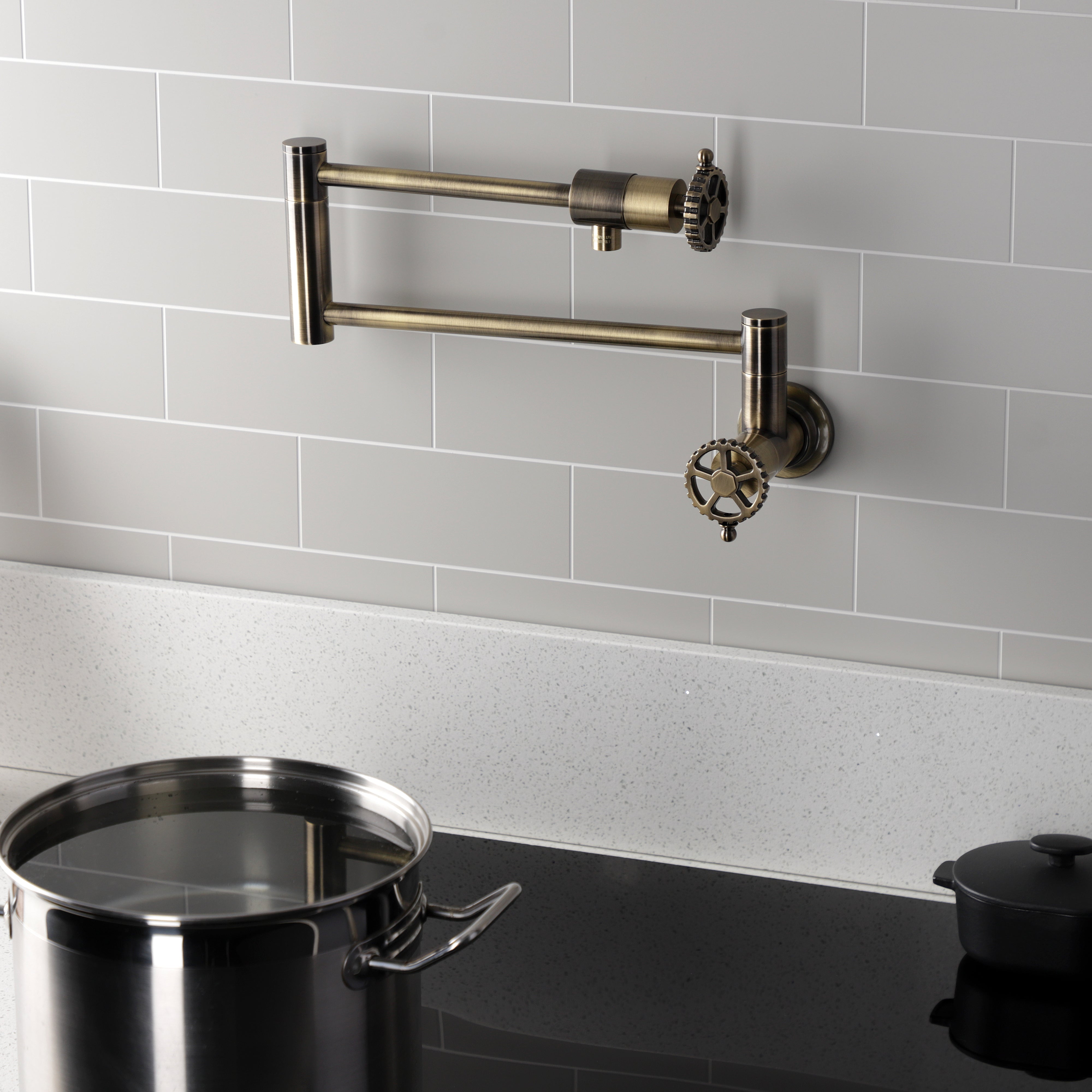 Kingston Brass KS4103CG Fuller Wall Mount Pot Filler Faucet, Antique Brass with foldable swing arms and pot.