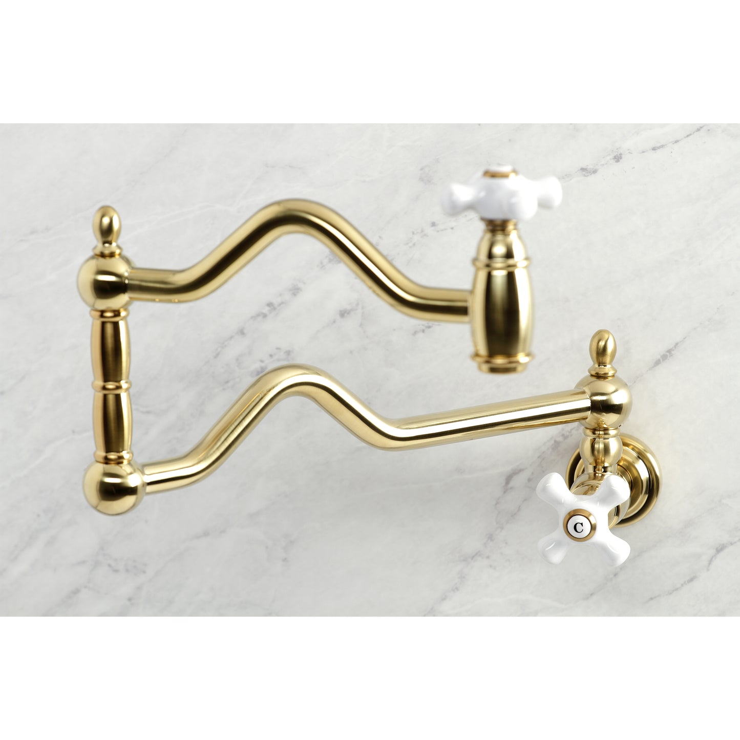 Kingston Brass KS2107PX Heritage Wall Mount Pot Filler Faucet, Brushed Brass on a marble surface