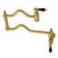 Kingston Brass KS2107PKL Duchess Wall Mount Pot Filler Faucet, Brushed Brass with black porcelain handles.