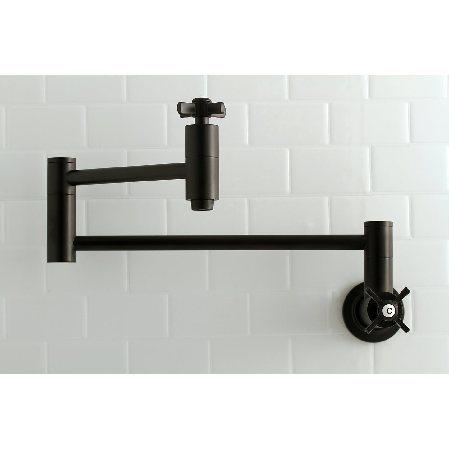 Kingston Brass KS8103ZX Millennium Wall Mount Pot Filler Faucet, Antique Brass on a white tiled wall.