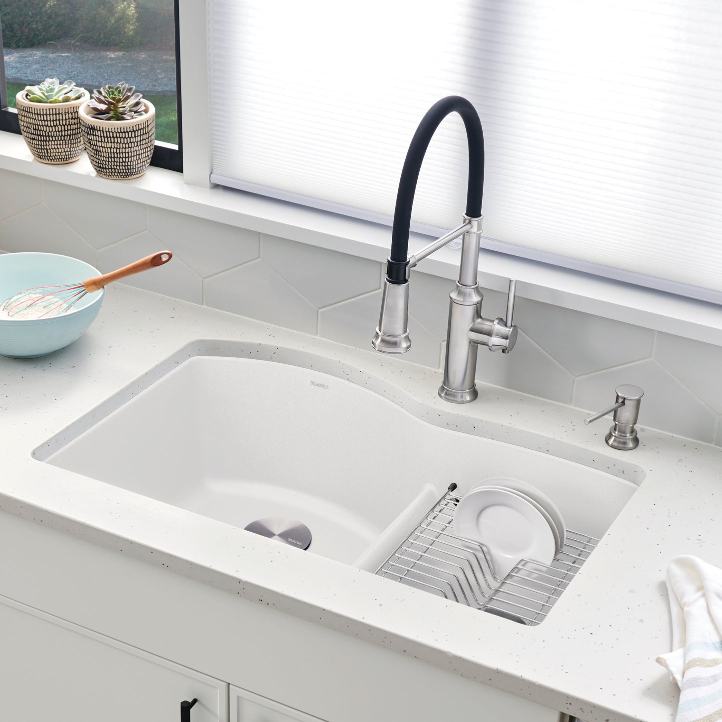BLANCO Diamond SILGRANIT 32" 60/40 Double Bowl Undermount Kitchen Sink with Low Divide on countertop with dishes.