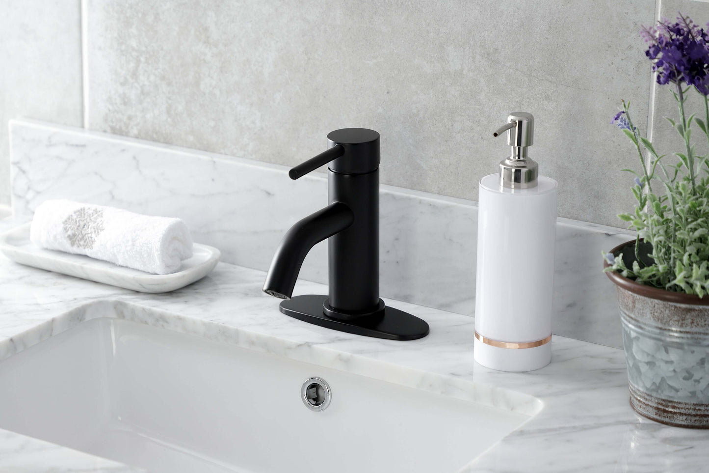 Kingston Brass LSF8223DL Concord Single-Handle Bathroom Faucet in streamlined design on a marble counter.