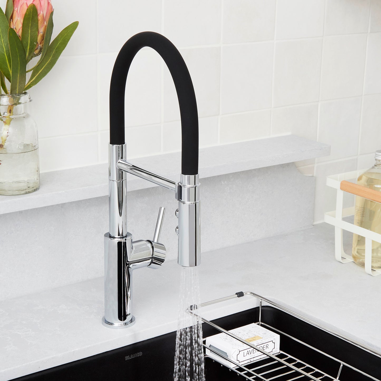 BLANCO Catris Flexo Semi-Pro Pull-Down Dual-Spray Kitchen Faucet in a modern kitchen setting with a flexible rubber hose.