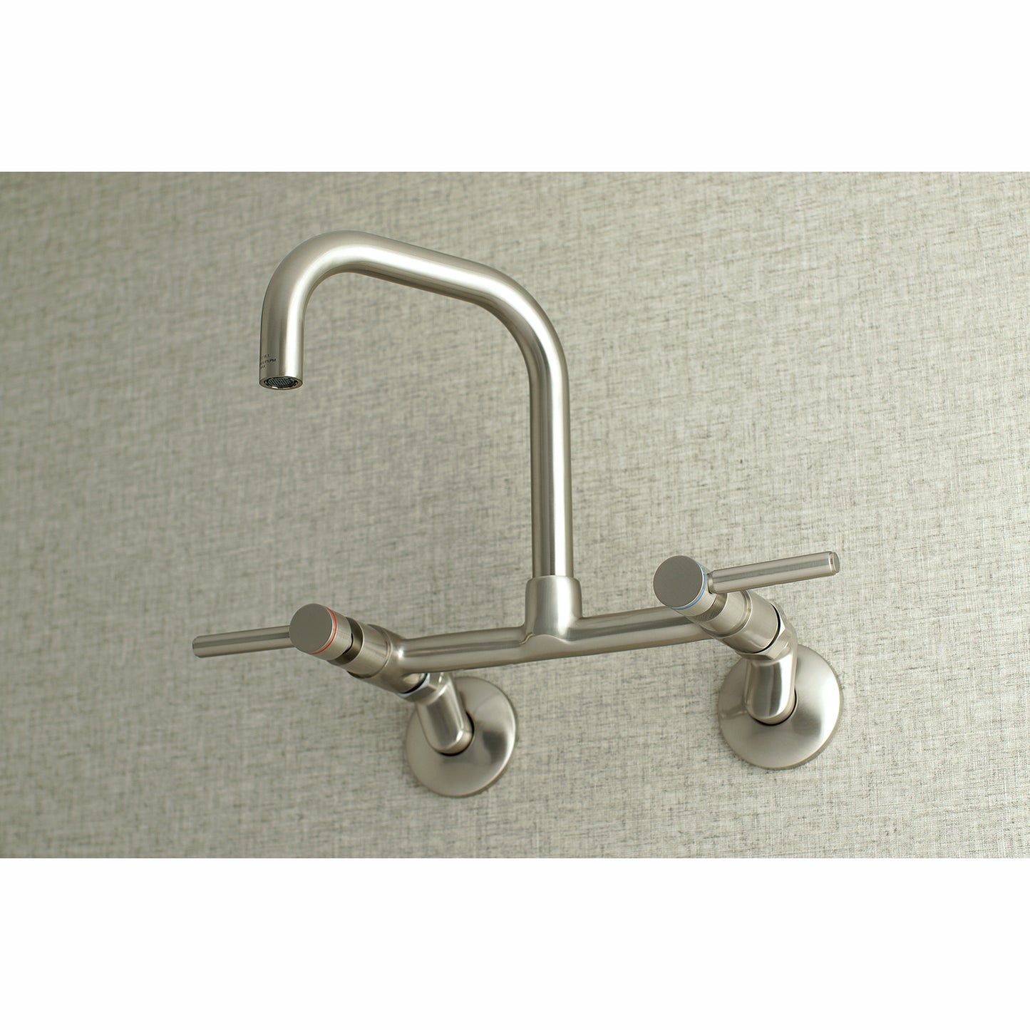Kingston Brass KS813SB Concord Wall Mount Bridge Kitchen Faucet, overhead view showcasing modern design and cylindrical styling.