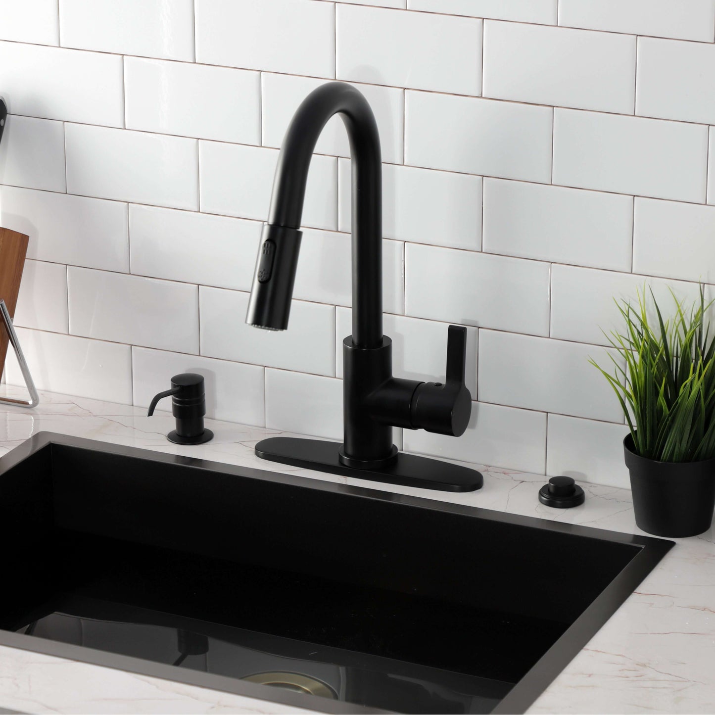 Kingston Brass LS8783CTL Continental Pull-Down Kitchen Faucet in a modern kitchen setting with a black sink.