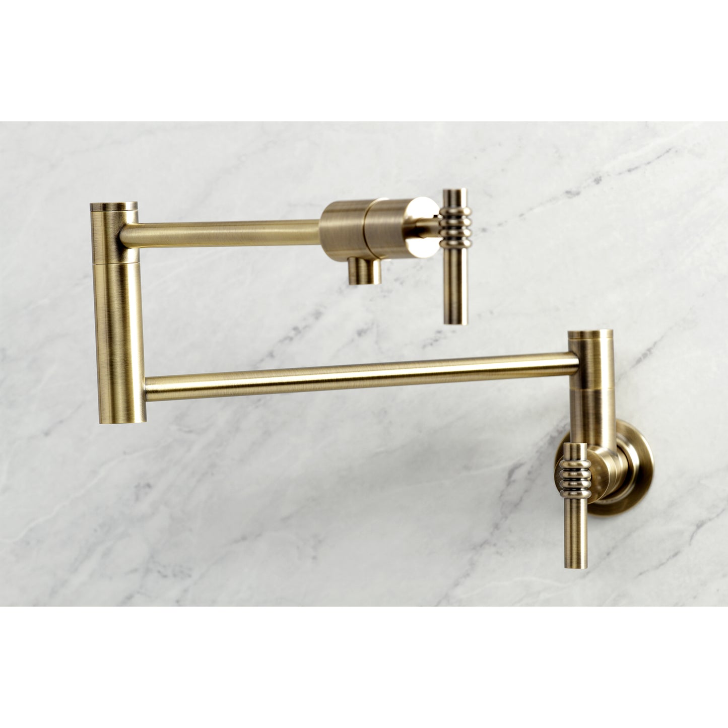 Kingston Brass KS4103ML Milano Wall Mount Pot Filler Faucet, Antique Brass close-up view on marble background