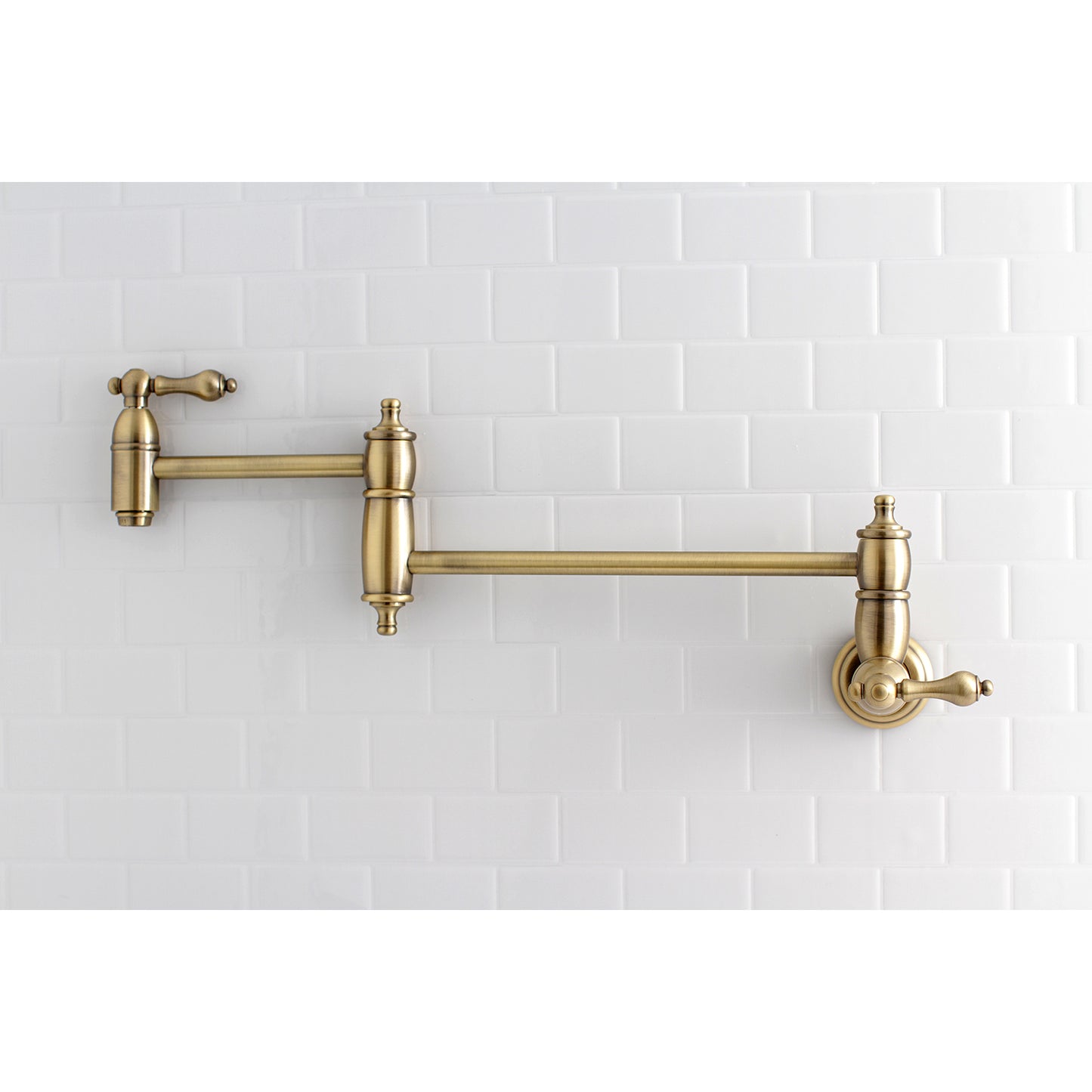 Kingston Brass KS3103AL Restoration Wall Mount Pot Filler Faucet, Antique Brass mounted on wall.