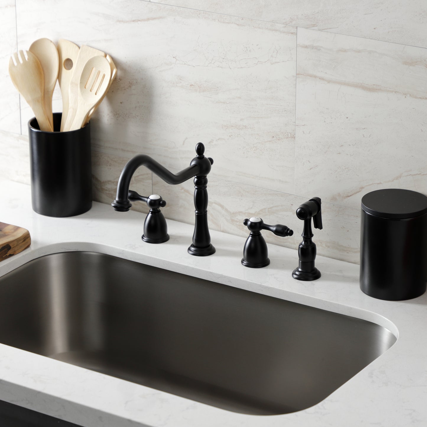 Kingston Brass KB1797TALBS Tudor Double-Handle Widespread Kitchen Faucet with Brass Sprayer, Brushed Brass in a modern kitchen setting.