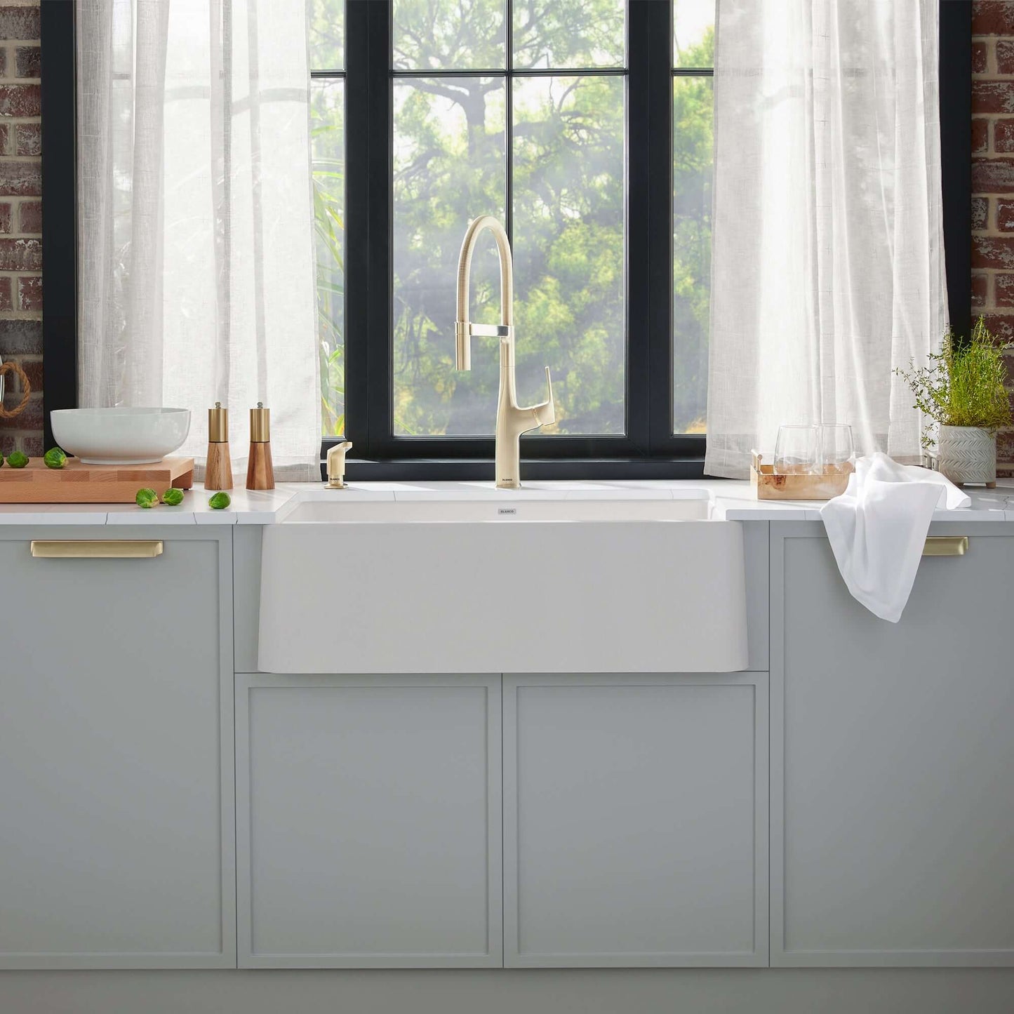 BLANCO Ikon SILGRANIT 33" Single Bowl Apron-Front Farmhouse Sink displayed in a stylish kitchen interior.