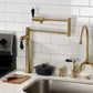 Kingston Brass KS4707PKL Duchess Deck Mount Pot Filler Faucet, Brushed Brass installed in a modern kitchen.