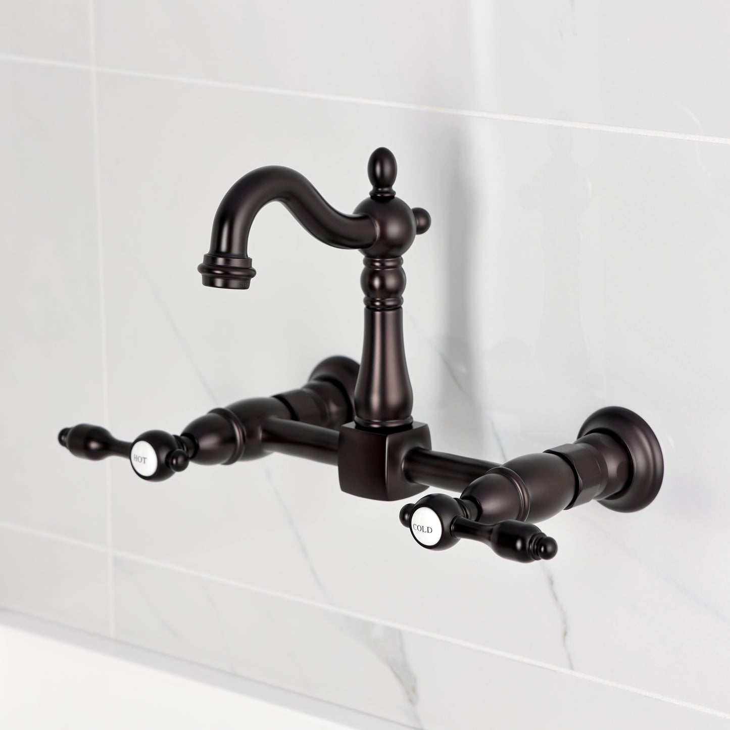 Kingston KS2443TAL Tudor Two-Handle Wall Mount Bridge Kitchen Faucet, Antique Brass design on marble background