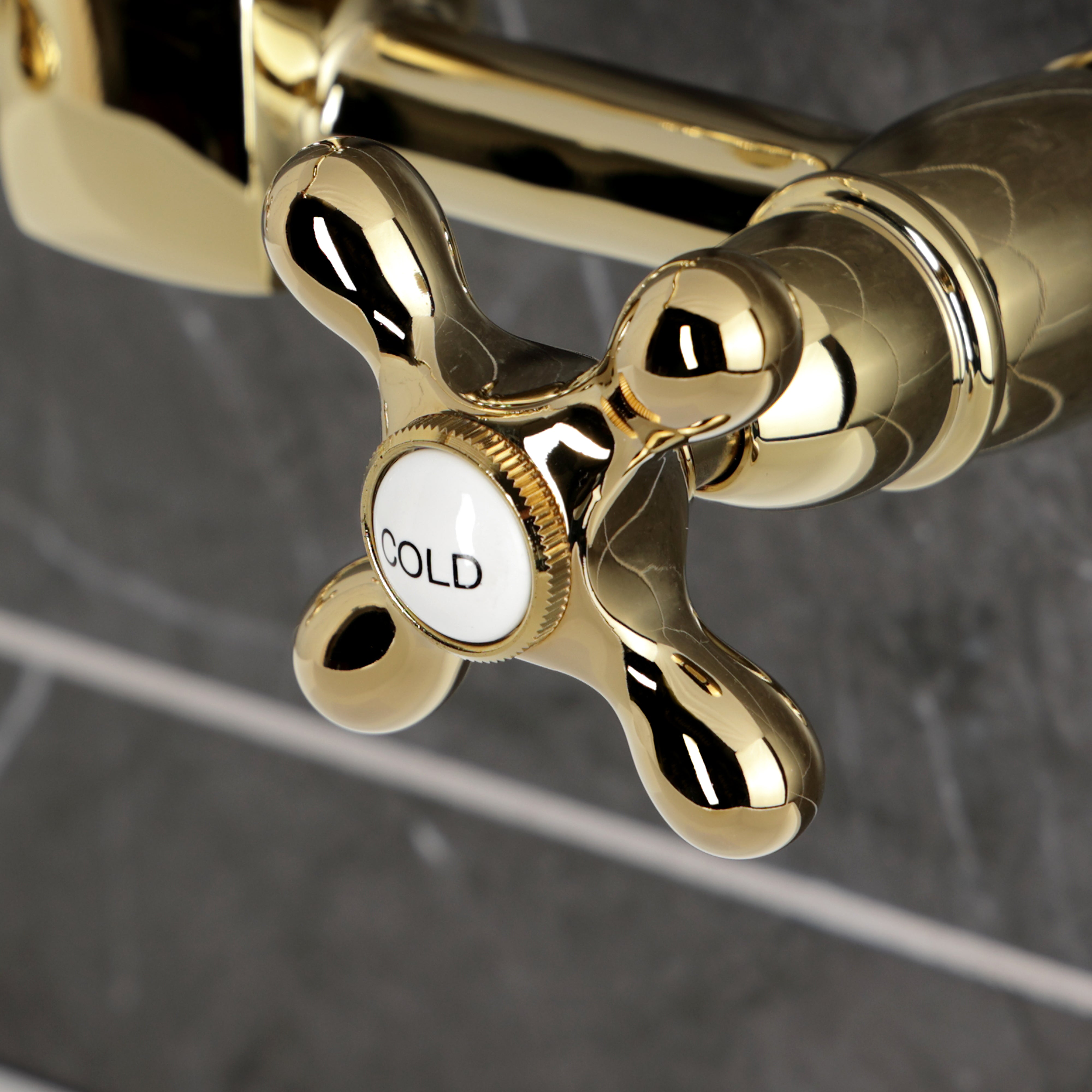 Kingston KS1263AX Heritage Two-Handle Wall Mount Bridge Kitchen Faucet, Antique Brass close-up of cold handle