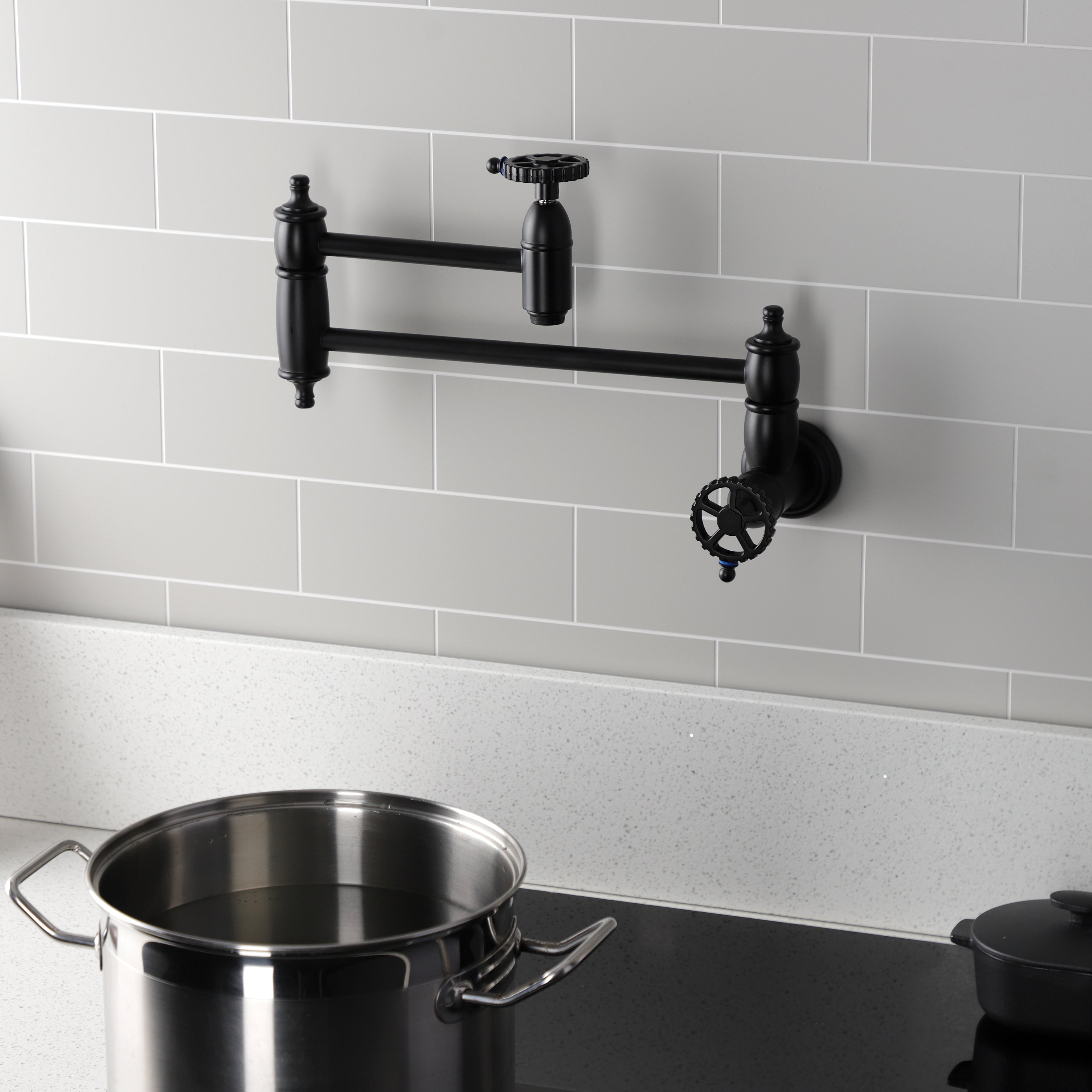 Kingston Brass KS3103CG Fuller Wall Mount Pot Filler Faucet, Antique Brass in a modern kitchen setting.