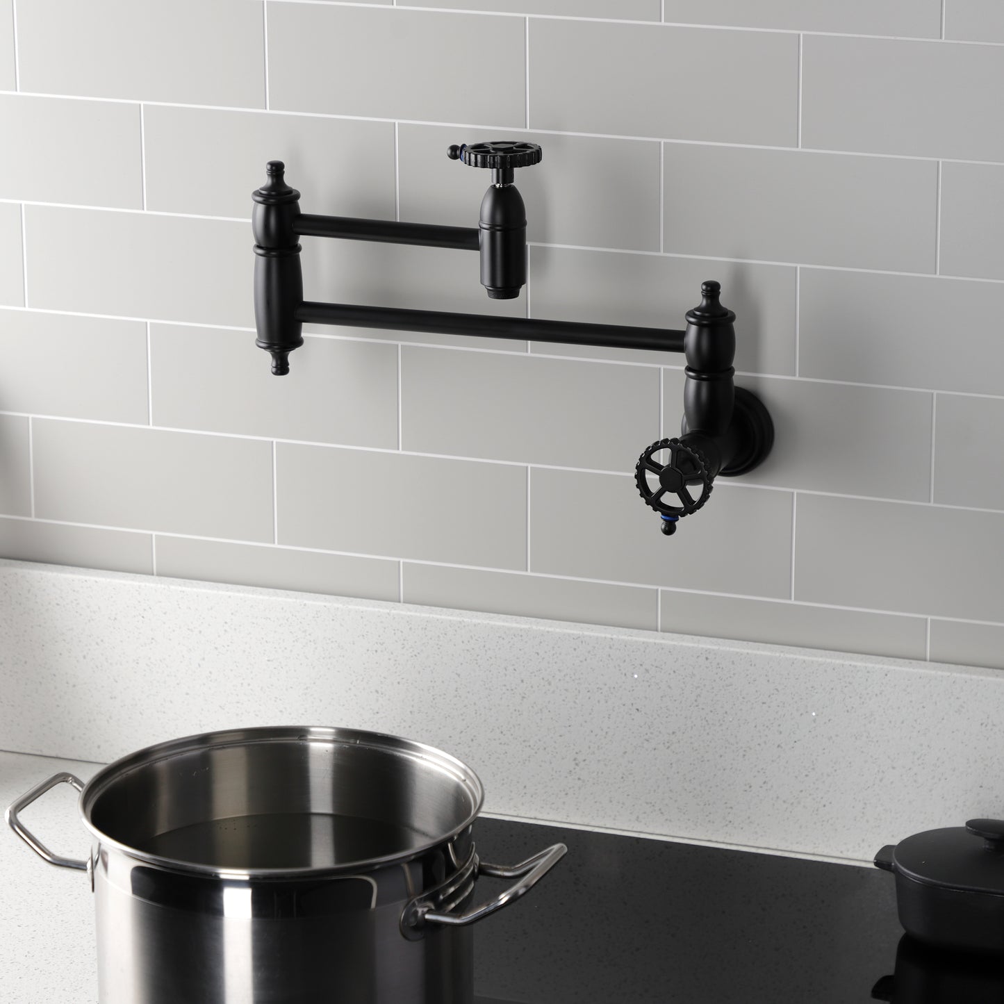 Kingston Brass KS3103CG Fuller Wall Mount Pot Filler Faucet, Antique Brass in a modern kitchen setting.