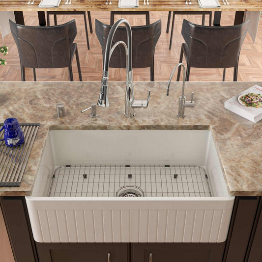 ALFI 33" White Single Bowl Fluted Apron Fireclay Farm Sink AB532-W installed in a contemporary kitchen with modern fixtures.