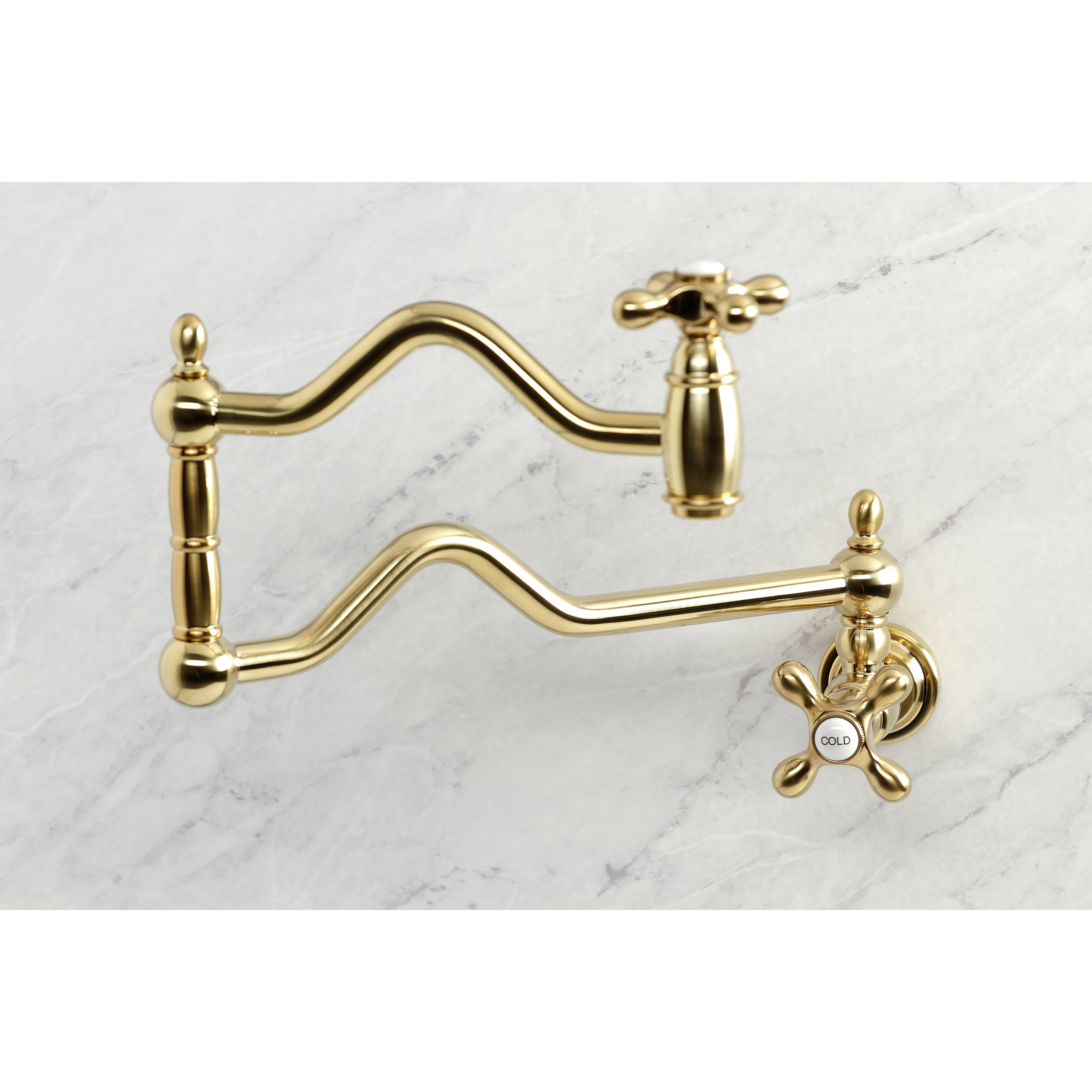 Kingston Brass KS2107AX Heritage Wall Mount Pot Filler Faucet, Brushed Brass with swing arms on a marble background.