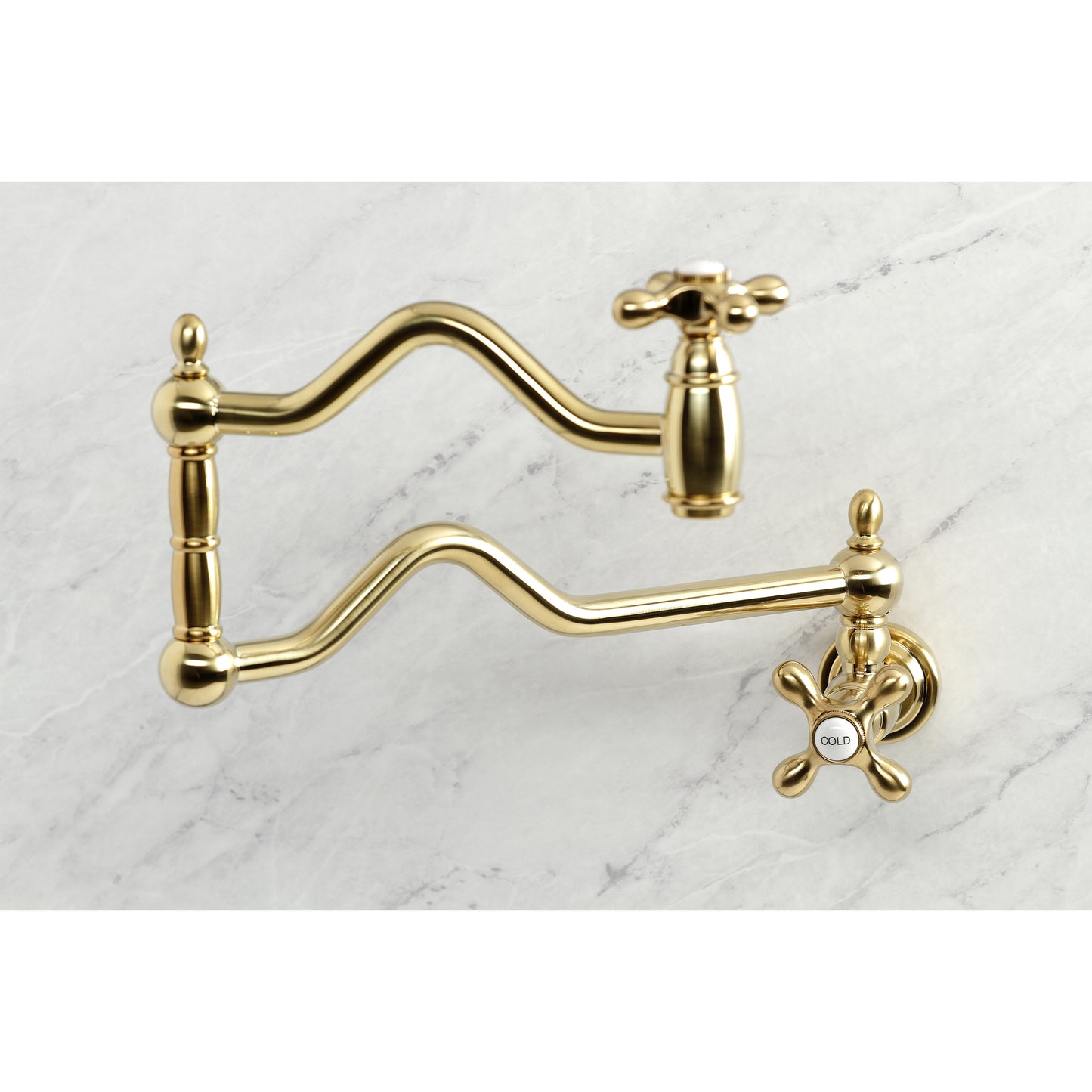Kingston Brass KS2107AX Heritage Wall Mount Pot Filler Faucet, Brushed Brass with swing arms on a marble background.