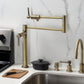 Kingston Brass KS4703DL Concord Deck Mount Pot Filler Faucet, Antique Brass shown in a modern kitchen setting.
