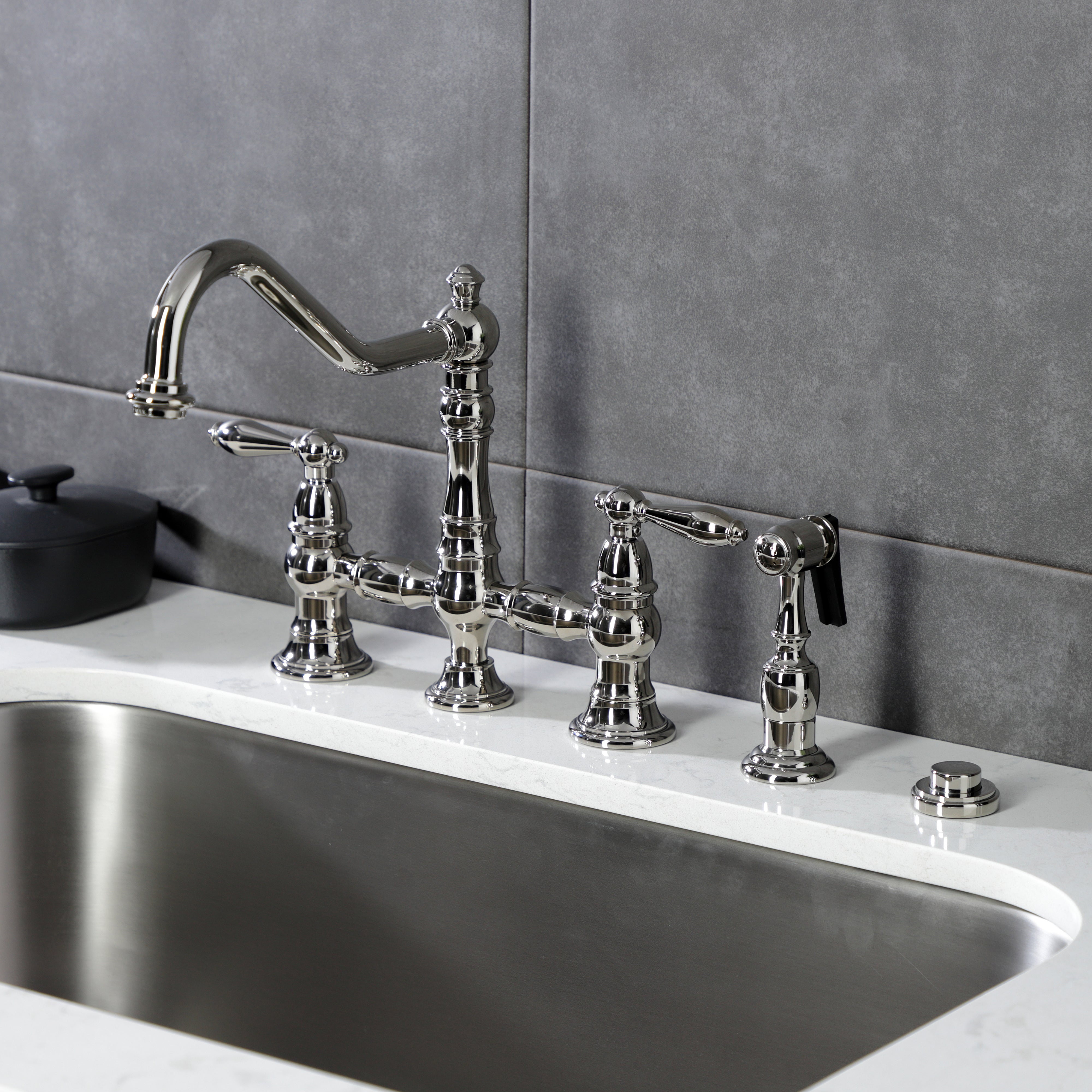 Kingston KS3277ALBS Restoration Bridge Kitchen Faucet with Brass Sprayer, Brushed Brass on kitchen counter.