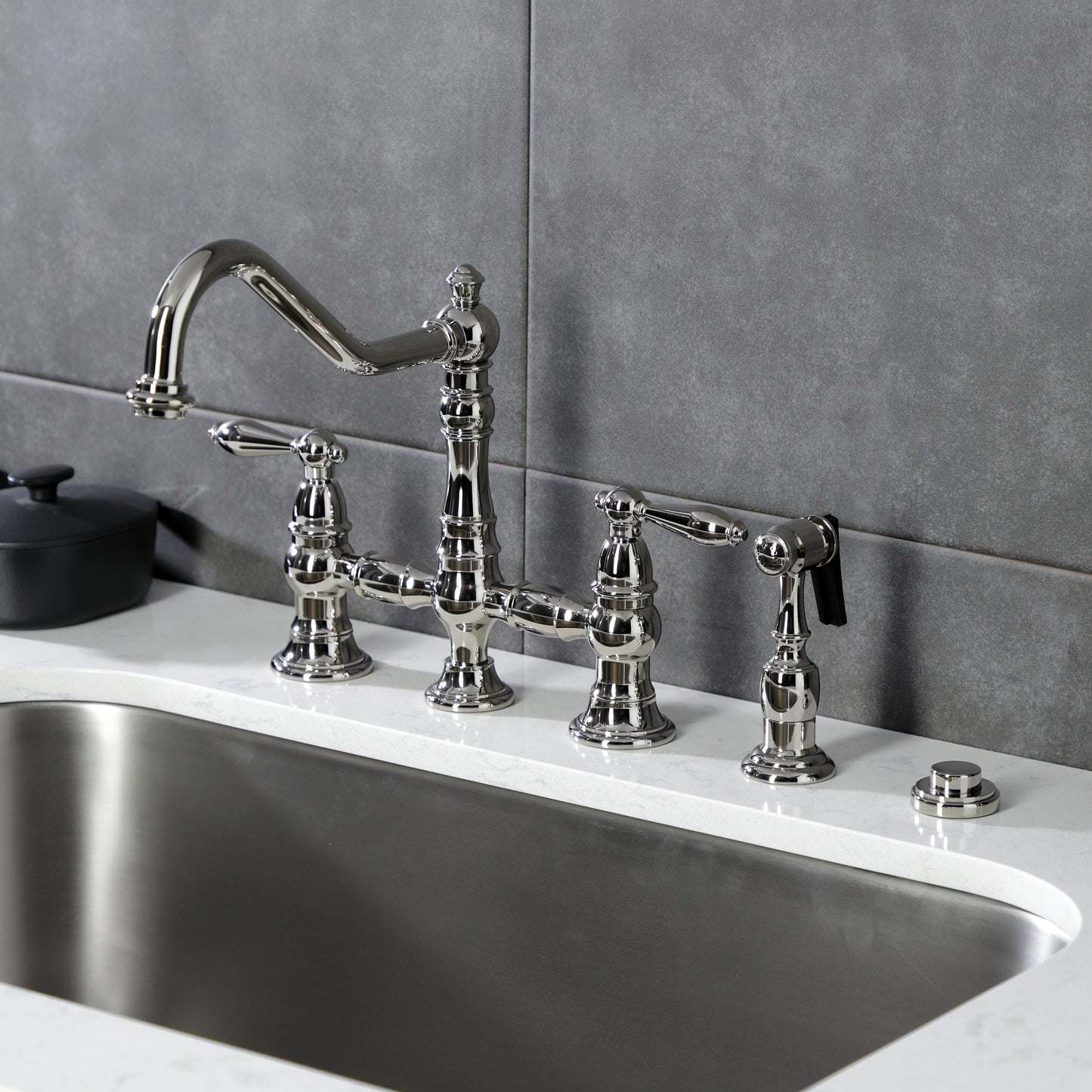 Kingston KS3277ALBS Restoration Bridge Kitchen Faucet with Brass Sprayer, Brushed Brass on kitchen counter.