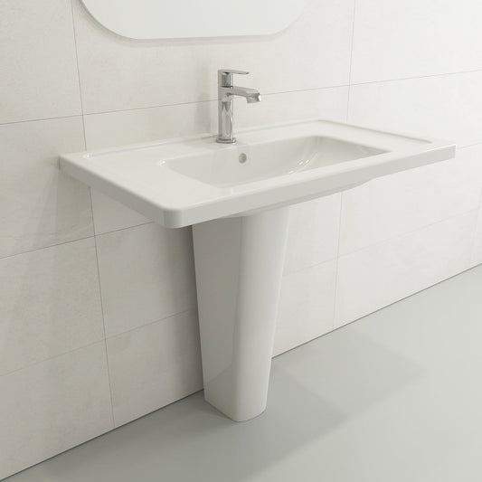 BOCCHI TAORMINA 27.25" Fireclay Pedestal Base with modern faucet on white tiled wall.