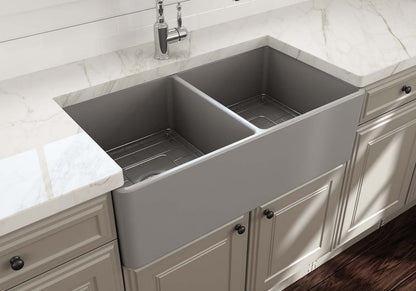 BOCCHI Classico 33" Fireclay Farmhouse Apron 50/50 Double Bowl Kitchen Sink in modern kitchen with marble countertop.