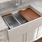Lifestyle image of white Bocchi Contempo 30" sink in a modern kitchen with colander and cutting board in use.