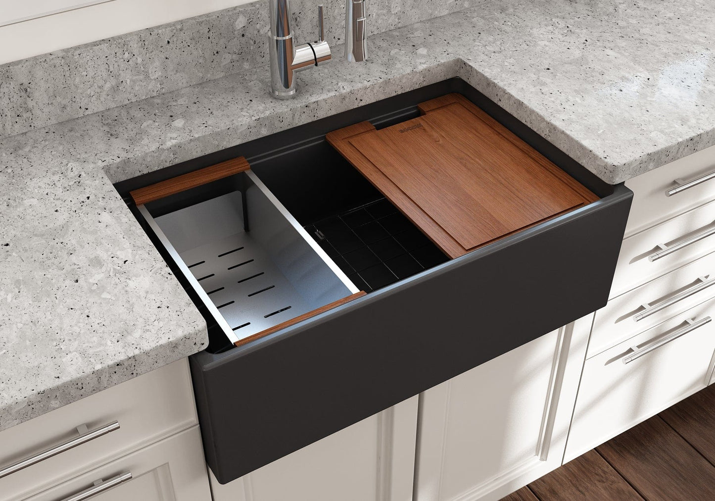 Lifestyle image of a matte dark gray Bocchi Contempo 30" sink in a modern kitchen with colander and cutting board in use.