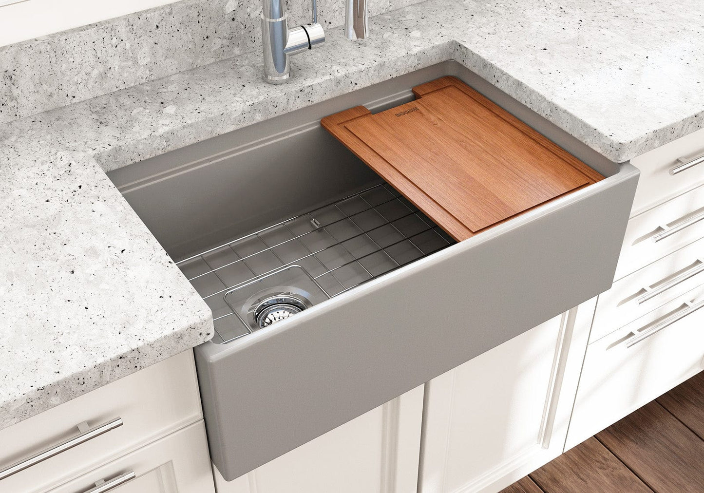 Lifestyle image of a matte gray BOCCHI Contempo 30" sink in a modern kitchen with cutting board in use