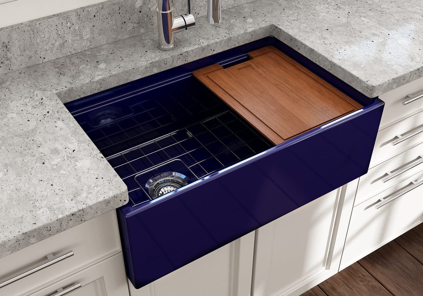 Lifestyle image of a sapphire blue BOCCHI Contempo 30" sink in a modern kitchen with cutting board in use