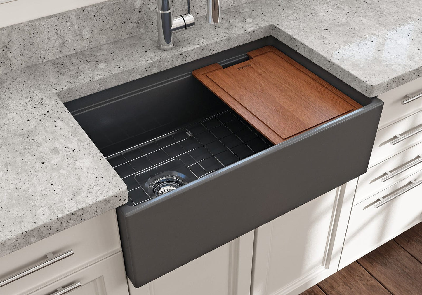 Lifestyle image of a matte dark gray BOCCHI Contempo 30" sink in a modern kitchen with cutting board in use