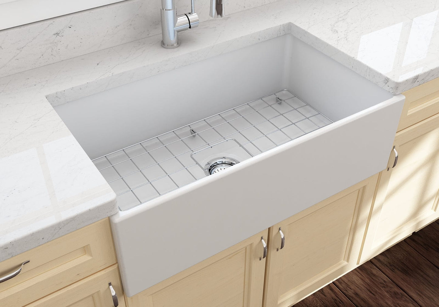 Lifestyle image of the Bocchi Contempo 33" Fireclay Farmhouse Sink in Matte White, showing included stainless steel bottom grid and strainer