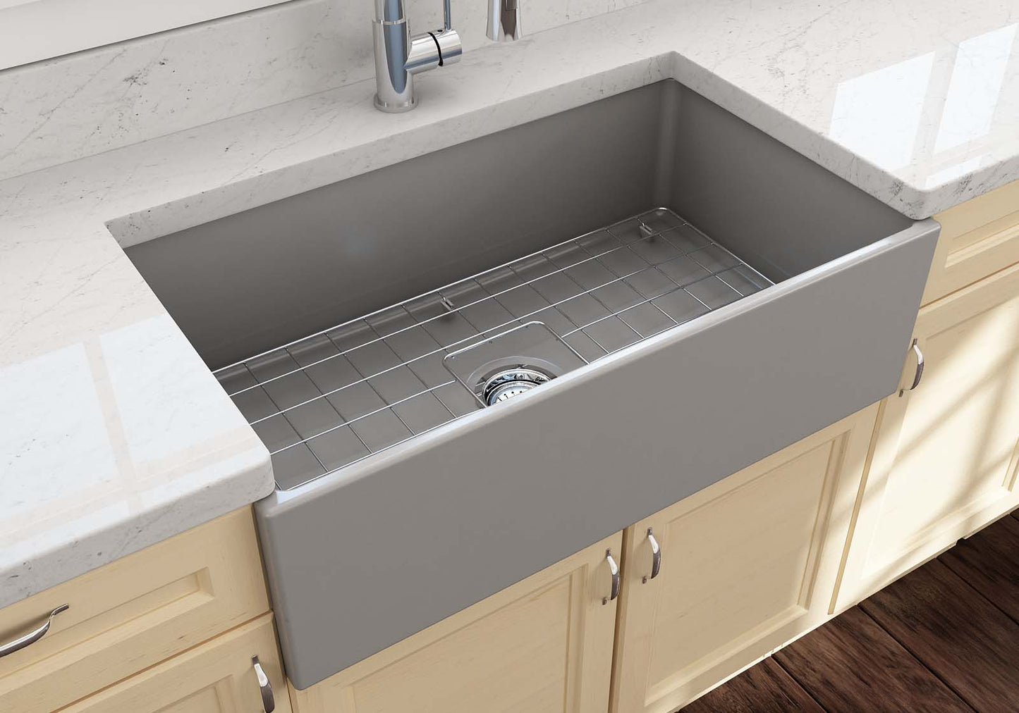 Lifestyle image of the Bocchi Contempo 33" Fireclay Farmhouse Sink in Matte Gray, showing included stainless steel bottom grid and strainer