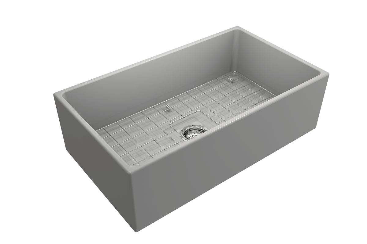 Top corner angle of Bocchi Contempo Fireclay Farmhouse Sink in Matte Gray showing center drain placement, bottom grid and included sink strainer
