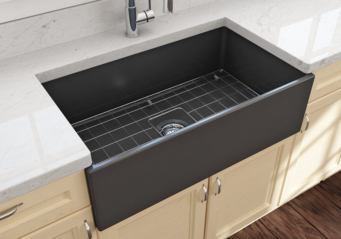 Lifestyle image of the Bocchi Contempo 33" Fireclay Farmhouse Sink in Matte Dark Gray, showing included stainless steel bottom grid and strainer