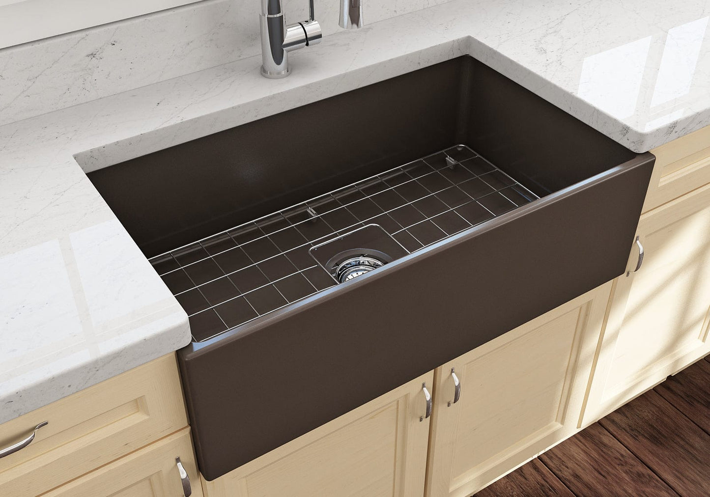 Lifestyle image of the Bocchi Contempo 33" Fireclay Farmhouse Sink in Matte Brown, showing included stainless steel bottom grid and strainer