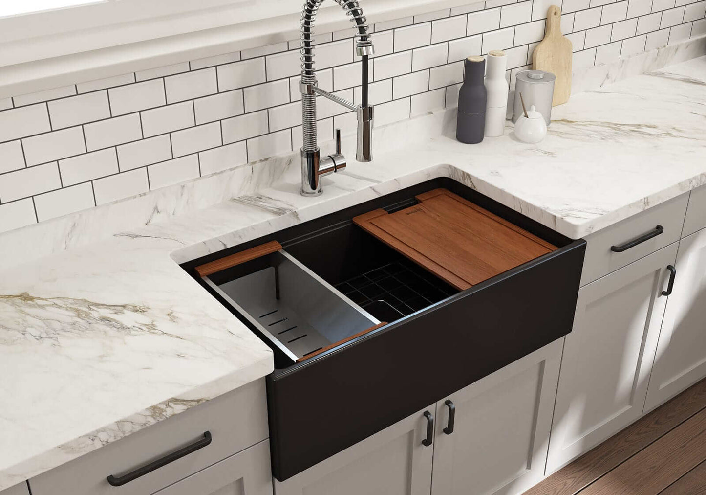 Lifestyle image of matte black step-rim BOCCHI Contempo 33" sink in a modern kitchen with colander and cutting board in use.