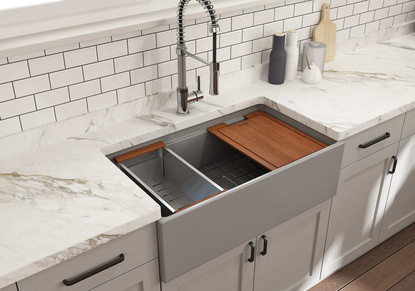 Lifestyle image of matte gray step-rim BOCCHI Contempo 33" sink in a modern kitchen with colander and cutting board in use.