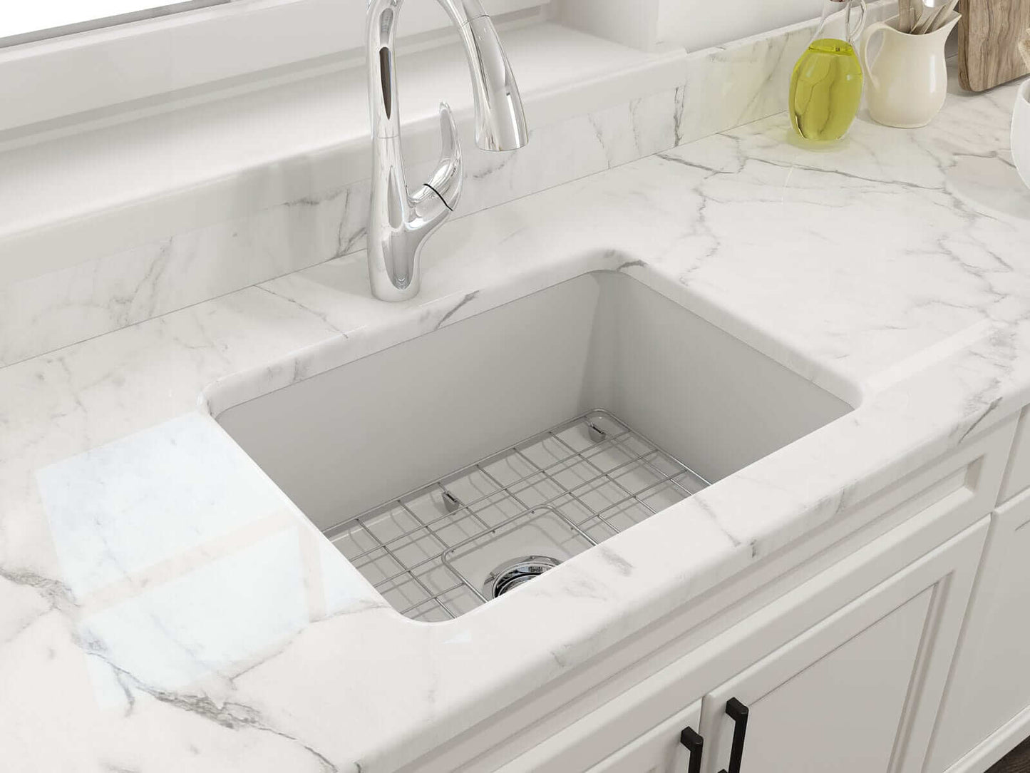 BOCCHI SOTTO 24" Fireclay Dual-Mount Single Bowl Sink with Bottom Grid & Strainer in matte white installed in a marble countertop.