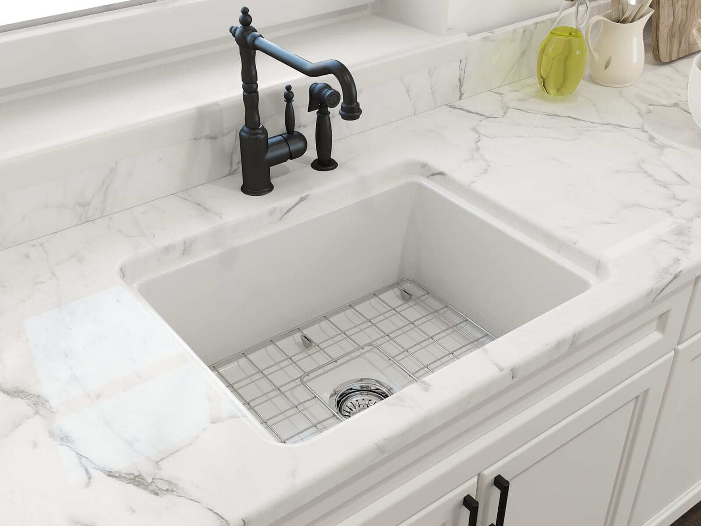 BOCCHI SOTTO 24" Fireclay Dual-Mount Single Bowl Sink with Bottom Grid & Strainer in white with marble countertop and black faucet.