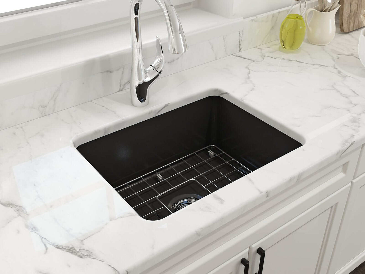 BOCCHI SOTTO 24" Fireclay Dual-Mount Single Bowl Sink with Bottom Grid & Strainer in Matte Black installed on a marble countertop.