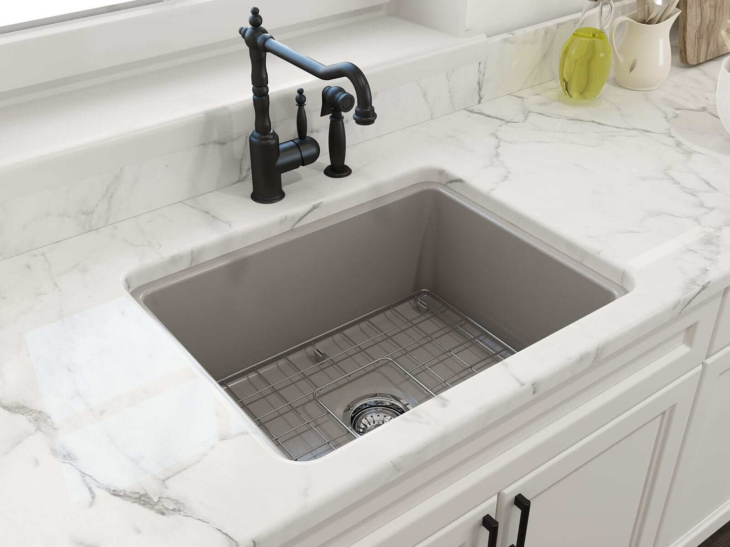 BOCCHI SOTTO 24" Fireclay Dual-Mount Single Bowl Sink with Bottom Grid & Strainer in a modern kitchen with marble countertop.