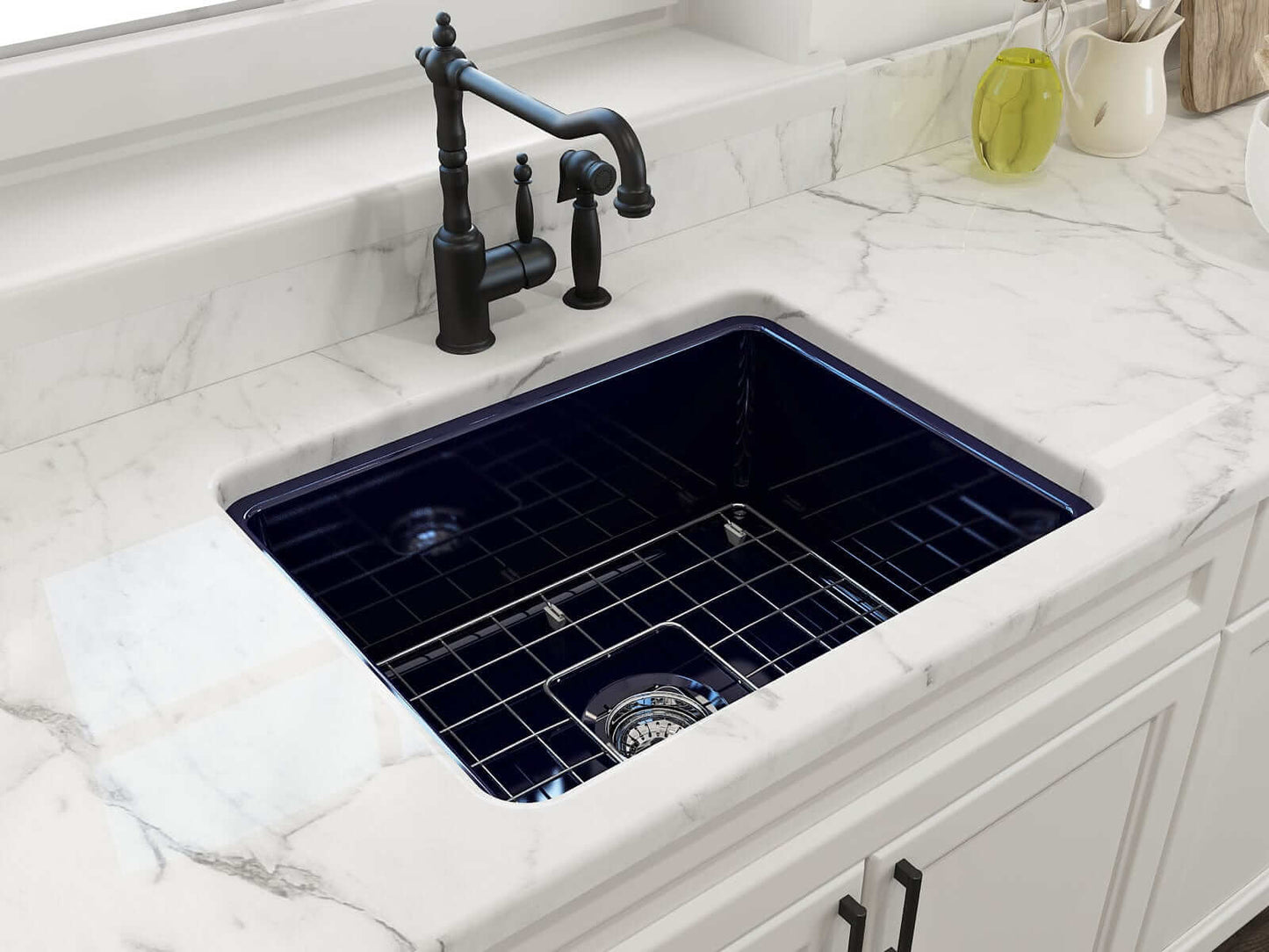 BOCCHI SOTTO 24" Fireclay Dual-Mount Single Bowl Sink with Bottom Grid & Strainer, navy blue finish, installed in marble countertop.
