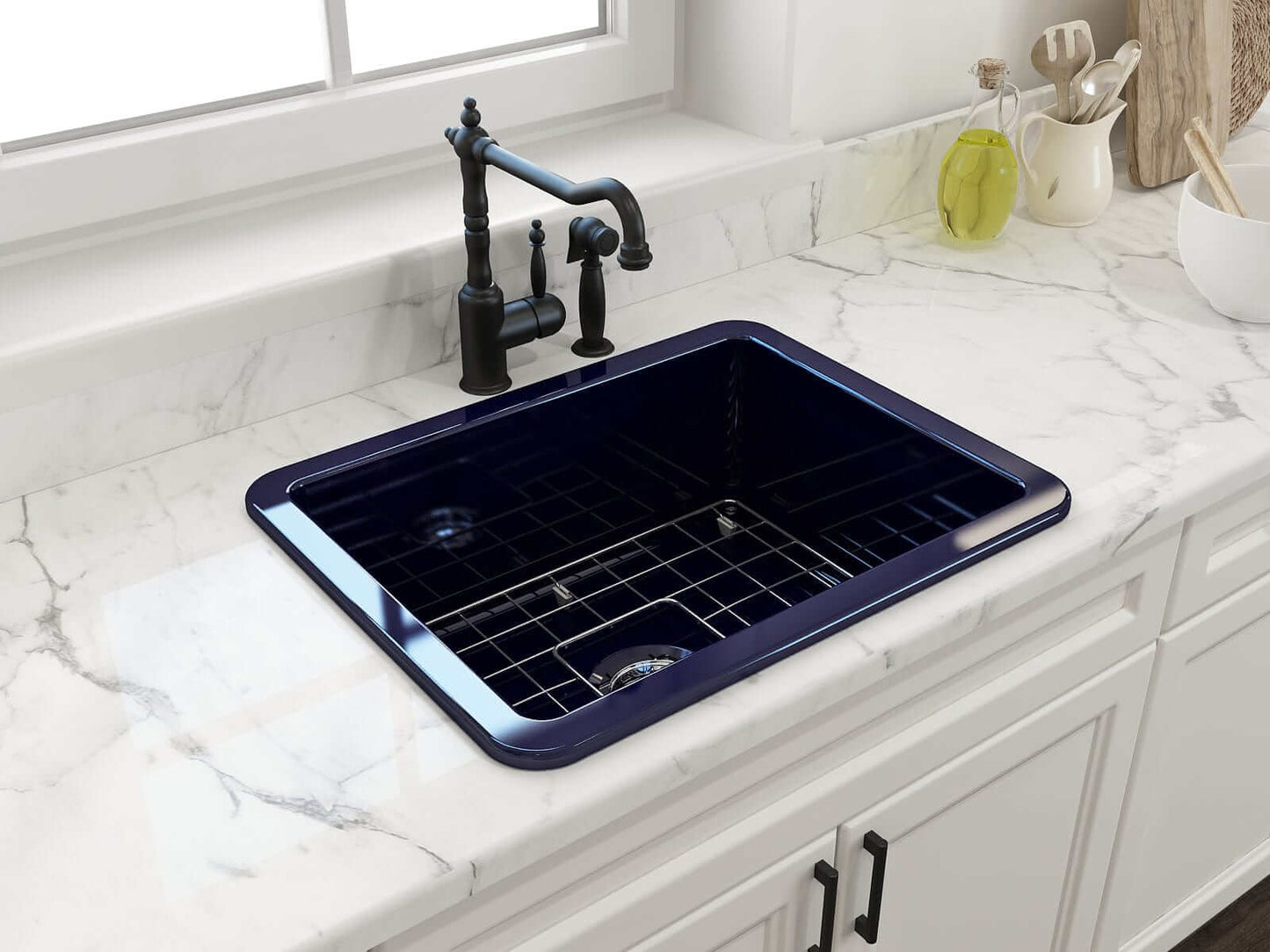 BOCCHI SOTTO 24" Fireclay Dual-Mount Single Bowl Sink with Bottom Grid & Strainer in navy blue on marble countertop.