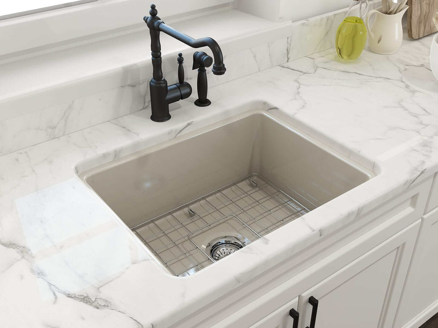 BOCCHI SOTTO 24" Fireclay Dual-Mount Single Bowl Sink with Bottom Grid & Strainer in beige finish on marble countertop.