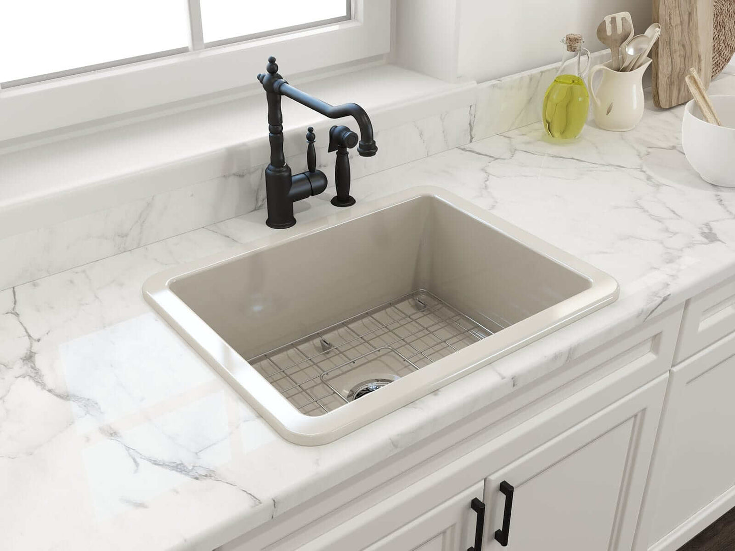 BOCCHI SOTTO 24" Fireclay Dual-Mount Single Bowl Sink with Bottom Grid & Strainer in beige with black faucet and marble countertop.