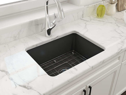 BOCCHI SOTTO 24" Fireclay Dual-Mount Single Bowl Sink with Bottom Grid & Strainer in Matte Dark Gray on marble countertop.