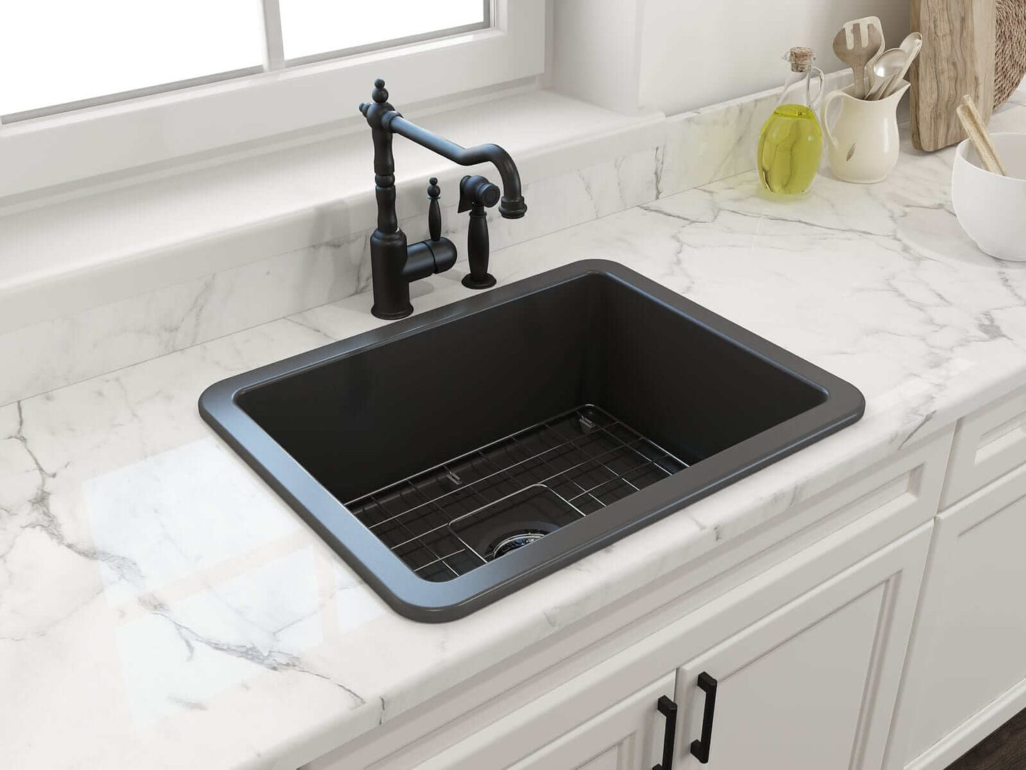 BOCCHI SOTTO 24" Fireclay Dual-Mount Single Bowl Sink with Bottom Grid & Strainer in a black finish with modern faucet on a marble countertop.